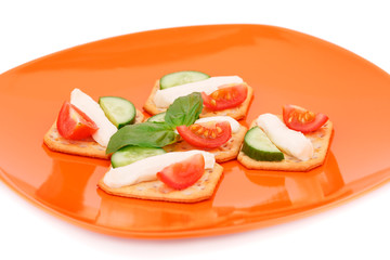 Crackers with fresh vegetables and cream