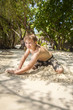 © travelview - happy young boy is digging in the sand