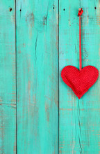 Red Heart Hanging On Antique Teal Blue Wood Background