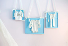 Blue Baby Clothes On The Clothesline Ribbons On The Wall