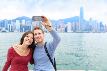 Selfie tourist couple taking picture in Hong Kong