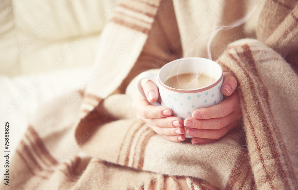 cup of hot coffee warming in the hands of a girl - obrazy, fototapety, plakaty 