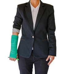 Injured businesswoman with green cast on hand and arm on white b