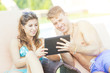 © william87 - Young Couple on Vacation using Digital Tablet