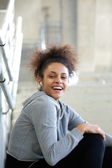 Poster - Smiling young woman listening to music with earphones