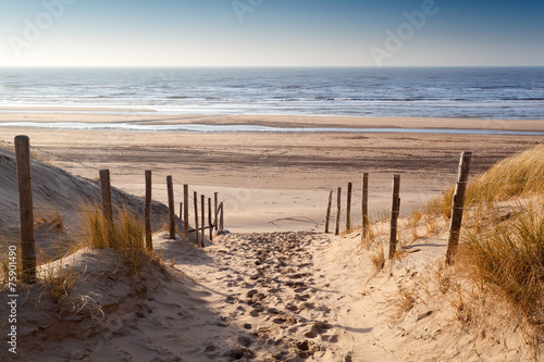 sand path to North sea at sunset