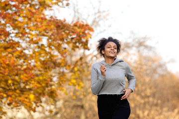 Poster - Healthy young woman jogging outdoors