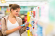 © lightpoet - Beautiful young woman shopping in a grocery store/supermarket