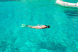 © travnikovstudio - Young woman snorkeling in tropical water on vacation