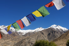 Snow Mountain Range And Tibetan Prayer Flags In The Village