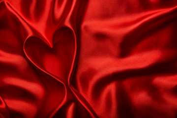 Heart shape silk fabric folds. Valentine day red background.