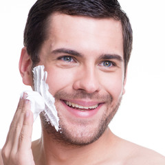 Wall Mural - handsome young man with a shaving foam