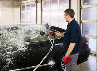 Wall Mural - Man worker washing luxury car on a car wash