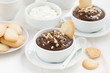 chocolate mousse with biscuits and nuts in white cups