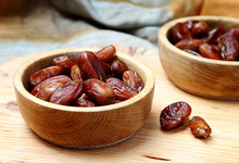 Fruits Dates In Wooden Bowl  On  Table