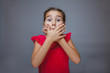 © maxximmm - Teen girl child hands covering her mouth feels fright shock on a