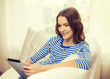 © Syda Productions - smiling teenage girl with tablet pc at home