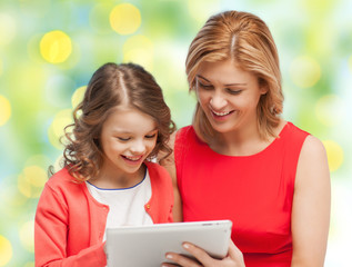 Canvas Print - mother and daughter with tablet pc over green