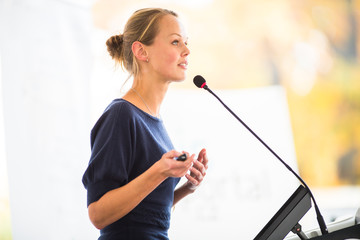 pretty, young business woman giving a presentation