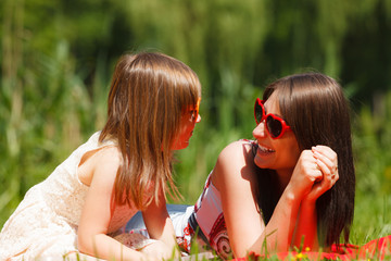 Wall Mural - Mother and daughter having picnic in park