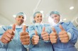 © WavebreakMediaMicro - Team of surgeons looking at camera showing thumbs up