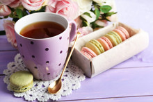 Colorful Macaroons With Cup Of Tea On Wooden Background