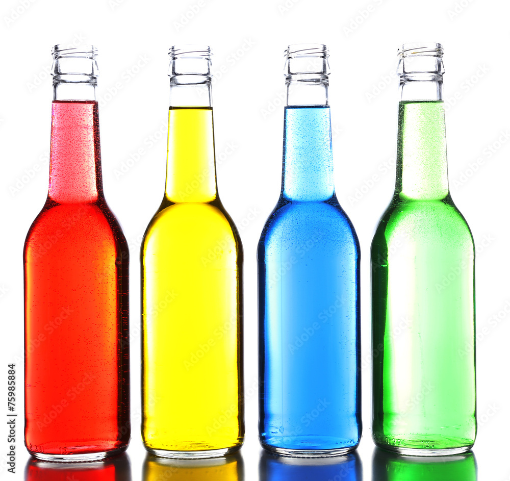 Colorful alcoholic beverages in glass bottles isolated on white