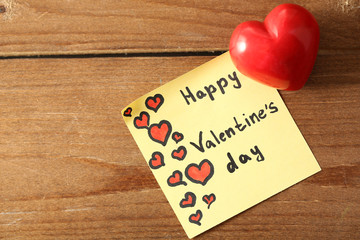 Valentines day note on wooden background