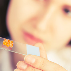 Canvas Print - girl in the laboratory of food quality tests caviar