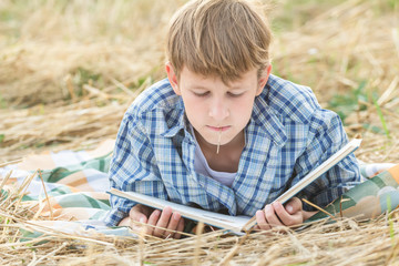 Sticker - Teenage boy lying with book