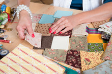 Close Up Of Woman's Hand Sewing Patchwork