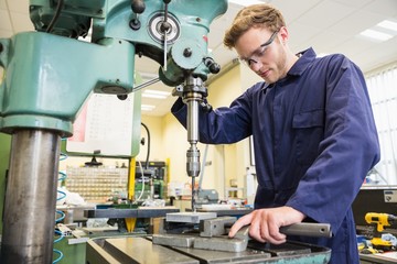 Engineering student using large drill