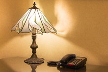 Table Lamp And Phone On Desk
