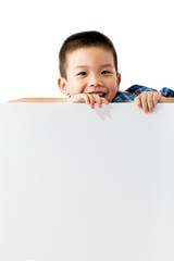 Portrait of happy little boy standing and holding empty white bo