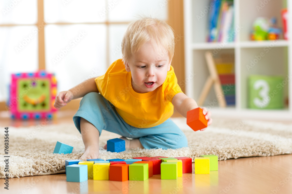 child toddler playing wooden toys at home - obrazy, fototapety, plakaty 