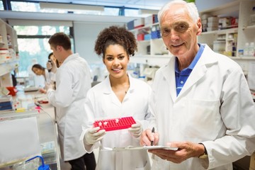 Wall Mural - lecturer and student smiling at camera in the lab