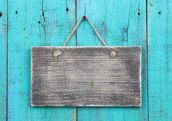 blank wood sign on teal blue wooden background