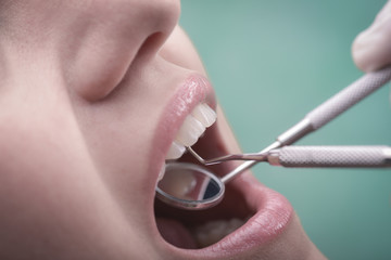 Young woman and dental instrument