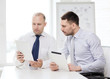 © Syda Productions - two serious businessmen with tablet pc in office