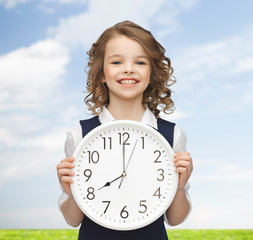 Wall Mural - smiling girl holding big clock