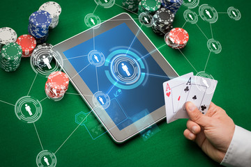 casino poker player with cards, tablet and chips