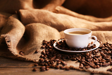 Poster - Cup of coffee with sackcloth on table