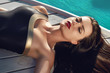 © indiraswork - Sexy woman is sunning by swimming pool have fun at beach party