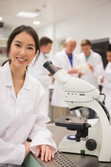 Wall Mural - young medical student working with microscope