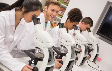 Wall Mural - medical students working with microscope
