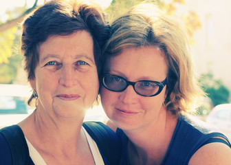 Portrait of beautiful senior woman and her adult daughter