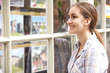 © highwaystarz - Smiling Young Woman Looking In Window Of Estate Agents