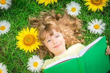 Wall Mural - Child reading in park