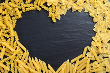 Heart shape made of fusilli, farfalle and penne pasta