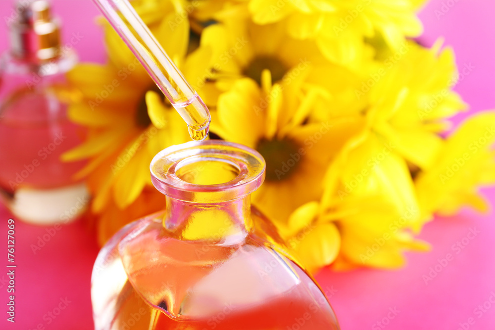 Dropper bottle of perfume with yellow chamomile